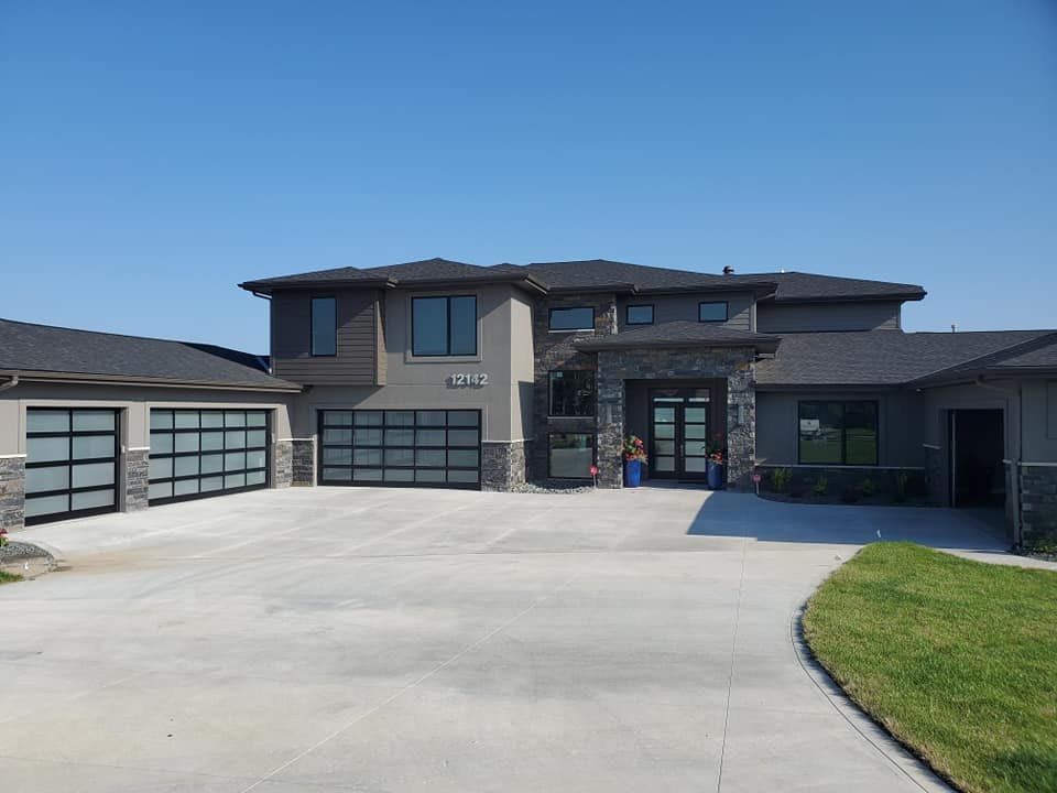 Luxury estate with black full-view garage doors