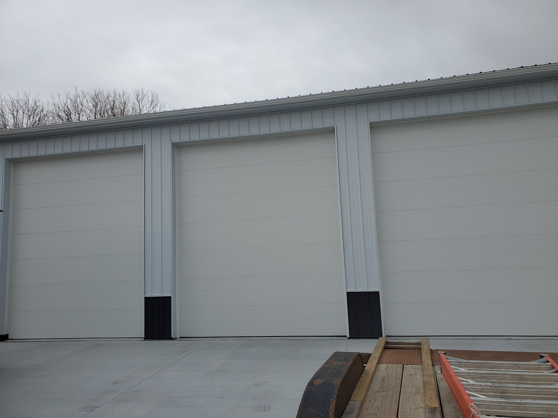 Three White V-Groove Panel Shop Doors